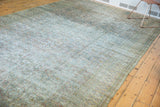 Decorative distressed field with subtle Herati pattern and wear in muted ivory and green.