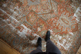 Heavy wear and distressed texture on a copper and silver Persian Karaja rug.