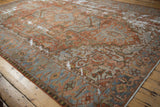 Storied wear across the geometric field of an antique Karaja rug in copper and oxidized silver tones.