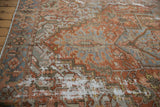 Angled view of hard wear and exposed foundation on a distressed antique Persian Karaja carpet.