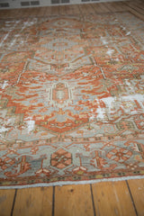 Low angle view across the antique Karaja rug, highlighting its storied wear and texture.