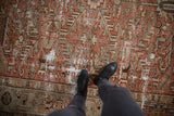 Distressed vintage Mehrivan carpet with an allover serrated leaf design in faded brick red and silver.