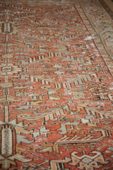 Distressed texture on vintage Mehrivan carpet, faded brick red and silver pattern.