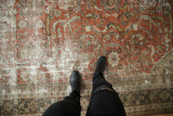 Distressed Mahal carpet with textured wear, dark terra cotta field, and flowing leaves pattern.