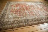 Distressed vintage Mahal carpet showing its charcoal border with intricate oxidized silver patterns.