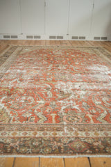 Textural distress with brick red and sand floral patterns on a vintage Mahal carpet.