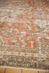 Detail of distressed Mahal carpet, highlighting worn pile, floral motifs, terra cotta and beige tones.