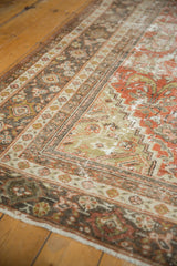 Distressed Mahal rug, featuring textured brick red wear and muted traditional patterns.