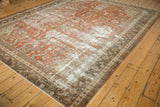 Bottom corner of distressed Mahal carpet with prominent wear, brick red field, and intricate borders.