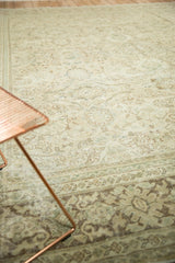 Muted ivory, pale green, and silver beige tones on a distressed vintage Mahal floral carpet.