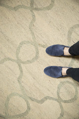 Detail of hand-woven Kilim carpet's ivory texture and pale slate grey Moroccan pattern.