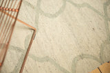 Ivory hand-woven Kilim texture with pale slate grey repeating Moroccan-inspired pattern.