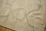 Moroccan tile inspired repeating vines in pale slate grey on an ivory Kilim carpet surface.