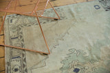 Distressed Oushak rug detail: even wear on knot heads, faded beige, green, charcoal patterns.