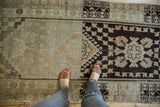 Distressed Oushak runner featuring faded light tones and dark chocolate brown traditional patterns.
