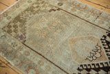 Distressed Oushak runner showing dark chocolate hook-and-latch detail and oxidized silver field.