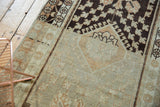 Muted chocolate brown and pale terra cotta motifs on the distressed vintage Oushak runner.