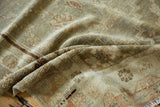 Distressed Oushak runner pile showing worn knot heads and faded beige, terra cotta patterns.