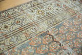 Distressed Malayer runner's terra cotta boteh and geometric beige border patterns.