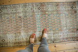 Distressed Malayer runner's allover boteh pattern in worn ocean green and terra cotta.