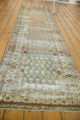 Patinaed geometric border and short fringe detail on vintage distressed Malayer runner.