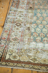 Distressed vintage Malayer runner's geometric border and ocean green field.