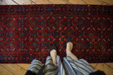 Vintage Engelas runner with ruby red field, sapphire blue Herati motif, and plush pile.