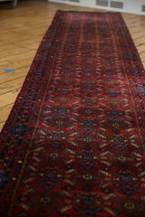 Plush, hand-knotted pile with ruby red field and intricate sapphire Herati motif.