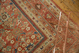Intricate corner detail of an antique Persian Mahal carpet, blush field and indigo floral lattice.