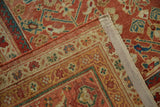 Secured edge of antique Mahal carpet with intricate terra cotta and blue border.