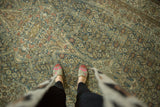 Distressed Malayer carpet with faded Herati motif, highlighting worn texture and soft blue palette.
