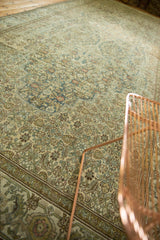 Softened Herati motif on a distressed vintage Malayer carpet, with blue, ivory, and sand tones.