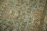 Distressed vintage Malayer carpet's Herati motif with denim blue, antique ivory, and soft madder root.