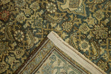 Vintage distressed Malayer rug corner, revealing time-softened Herati pattern in blue, ivory, and beige, with secure edge.