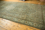 Distressed vintage Persian Malayer carpet with muted blue medallion and Herati field.