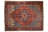 Vintage Heriz carpet, bold central medallion on madder red field with sky blue spandrels.