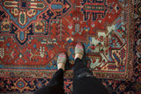 Evenly worn texture of a Vintage Heriz carpet with madder red and blue serrated leaves.
