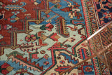 Geometric field motifs and powder blue corner spandrel on a vintage Heriz rug.