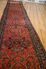 Full length view of a vintage Lilihan runner's blush pink floral pattern and dark navy border.