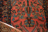 Close view of a Lilihan runner's low pile, with navy blue botehs and blush floral elements.