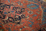 Antique Heriz carpet with rich madder red, sapphire blue, and mallard green geometric motifs.