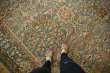 Distressed vintage Mahal carpet showing faded denim blue, blush, and ivory floral patterns.