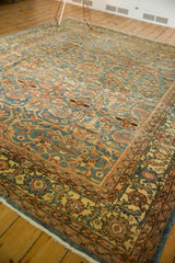 Corner of distressed Mahal carpet, showing white fringe and faded floral patterns.