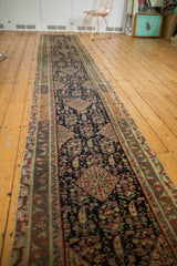 Geometric border and navy field with henna plant and paisley motifs on antique Malayer runner.