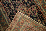 Antique Malayer runner detail: navy field with intricate paisley, revealing hand-knotted foundation.