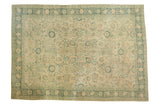 Distressed Tabriz carpet, ivory field with muted blue Safavid palmette and vine motifs.