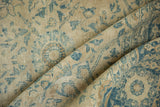 Folded vintage Tabriz carpet texture with faded antique ivory and blue Safavid pattern.