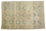 Vintage distressed hand-knotted Sivas rug, denim blue lattice, ivory floral medallions.