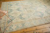 Distressed Sivas carpet, denim blue, ivory, and coffee brown lattice and floral motifs.