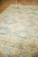 Faded denim blue and ivory lattice floral patterns on a distressed Sivas carpet.